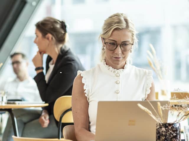 Person sitting with a laptop.