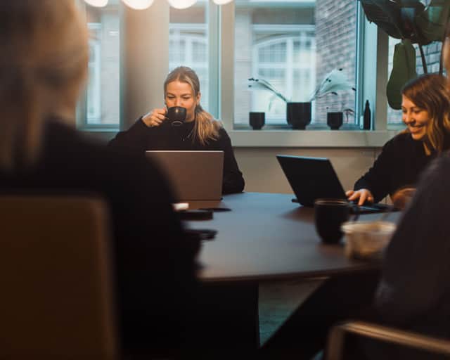 Two people standing by a table.